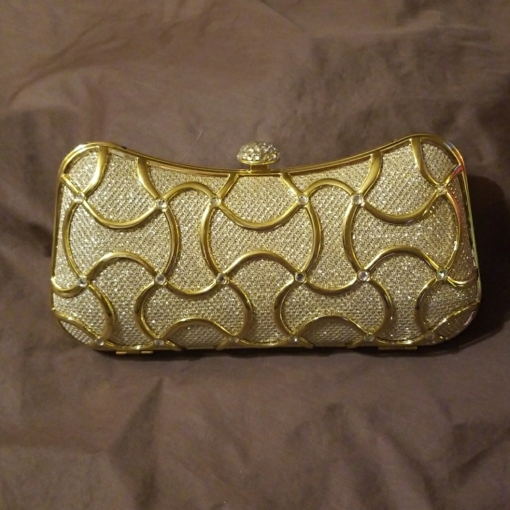 Fawziya Crystal clutch with gold chained strap.